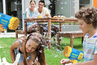 family playing with bubble machines