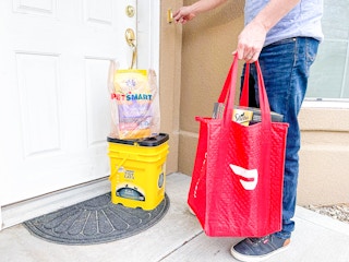 a doordash delivery person dropping off petsmart delivery