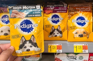 Hand holding one Pedigree Dog Food Pouch in front of shelf at Walmart. Price on shelf indicates that the price is $1.08.