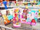 Three dolls (different brands) in Walmart shopping cart in toy aisle