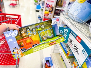 hand holding a bluey turtleboy bundle playset in front of target signage