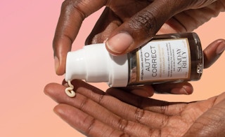 a hand pumping eye cream in another hand 