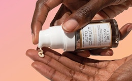 a hand pumping eye cream in another hand