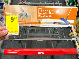 hand holding sales tag in front of box of Bona microfiber mop