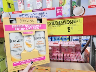 hand holding jergens lotion in sams club with instant savings sign