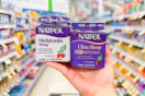 hand holding two Natrol products in a store