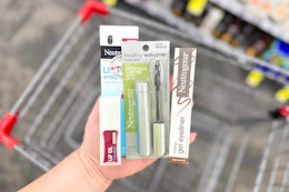 person holding neutrogena makeup products over a cart