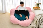 Lifestyle image of a kid on a flower-shaped bean bag cushion