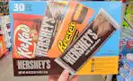 hand holding a box of hersheys bars