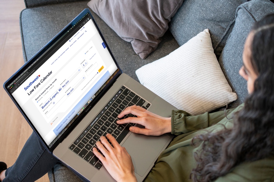 A woman looking at Southwest airlines website on a laptop computer