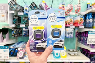hand holding 2 febreze car air freshener at target