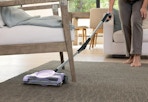 person using the Shark floor sweeper