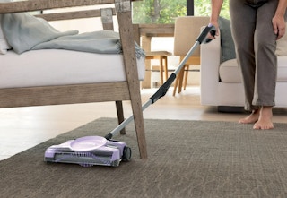 person using the Shark floor sweeper