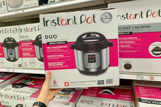 Woman holding isntant pot duo in target