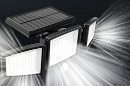 Lifestyle image of a solar light with beams of light shining (black background)