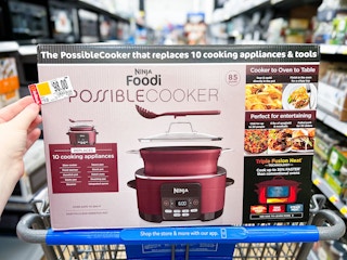 hand holding tag over ninja foodi possible cooker in walmart cart