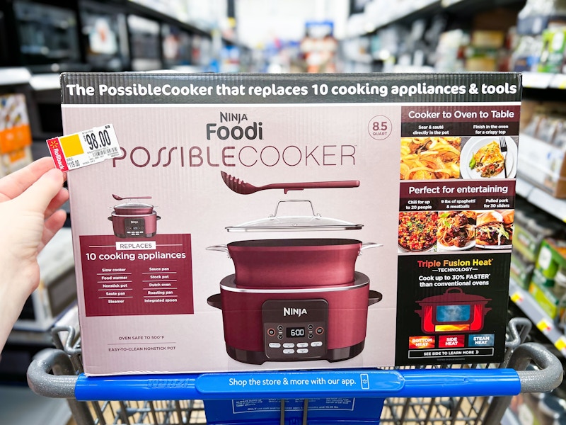 hand holding tag over ninja foodi possible cooker in walmart cart