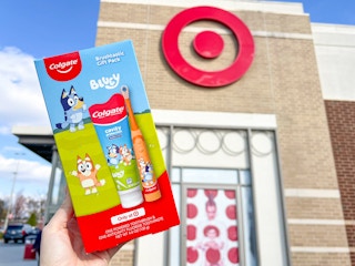 hand holding a bluey colgate kids' toothbrush gift set in front of target