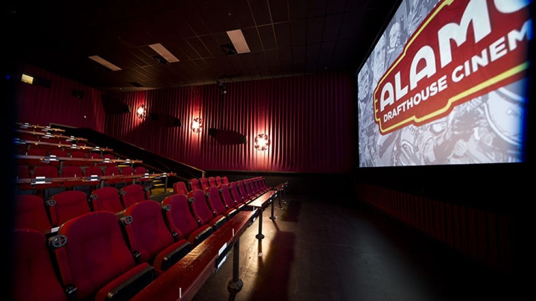 Inside an Alamo Drafthouse Cinemas theater, showing seats and screen