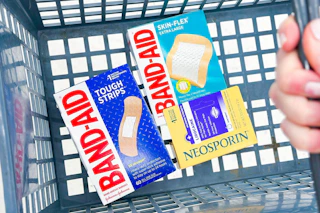 band-aid and neosporin in a shopping basket