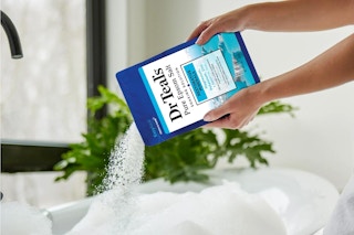 dr teal's epsom salt poured in a tub