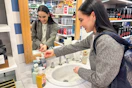 a person washing their hands at a sink with soap