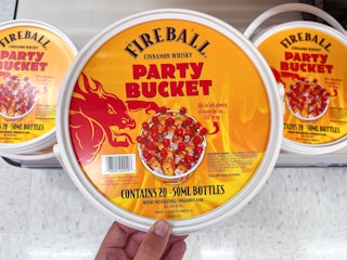 hand grabbing a fireball party bucket off a shelf at target