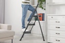 Lifestyle image (close up shot) of person using the ladder in home setting (bookshelf) 