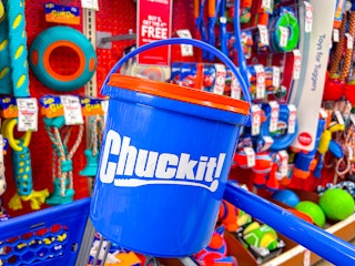 chuck it bucket in a cart in front of dog toys