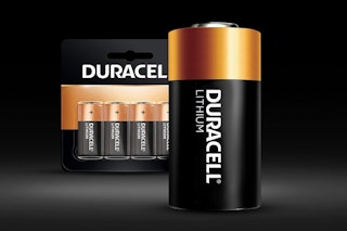 a single battery next to a package of batteries