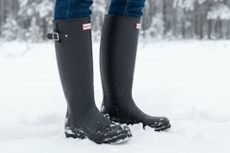 women wearing hunter boots in the snow 