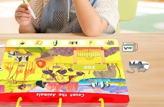 a little kid doing an activity in a busy book