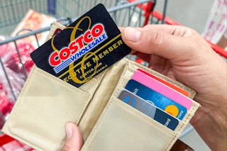 someone pulling their Costco Executive membership card out of their wallet