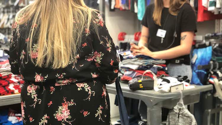 a woman speaks to an employee at old navy