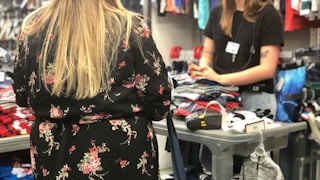 a woman speaks to an employee at old navy