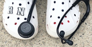 healthcare worker wearing white crocs near stethoscope