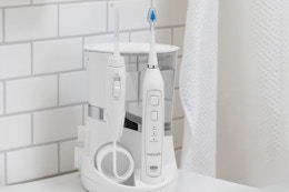 lifestyle image of a waterpik on a counter