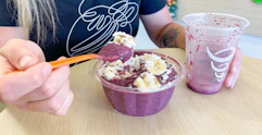 Someone eating an acai bowl at Jamba Juice