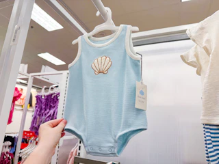 Cloud Island baby romper with sea shell design on rack in Target store