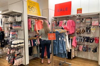 Someone shopping in a sale section in a GAP store