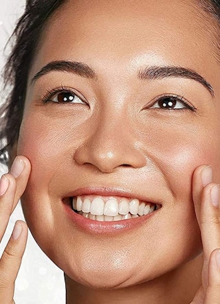 A woman with bright, clear skin smiling.