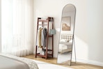 Lifestyle image of EDX arched floor mirror set up in bedroom