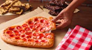 Pizza hut Valentines heart pizza with brownie and cookie slices in the background