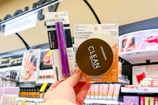 hand holding covergirl mascara and powder