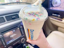 dutch bros birthday cake drink being held in a car