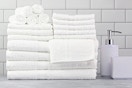 Lifestyle image of the white 100% cotton Mainstays 18 Piece Towel Set on bathroom counter 