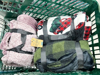 three sherpa blankets in a green DSG shopping cart