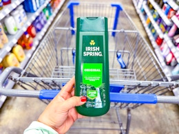 hand holding a bottle of irish-spring-body-wash in front of walmart cart