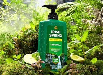 a green bottle of body wash in a forest 