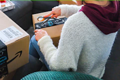 a woman opening an amazon package